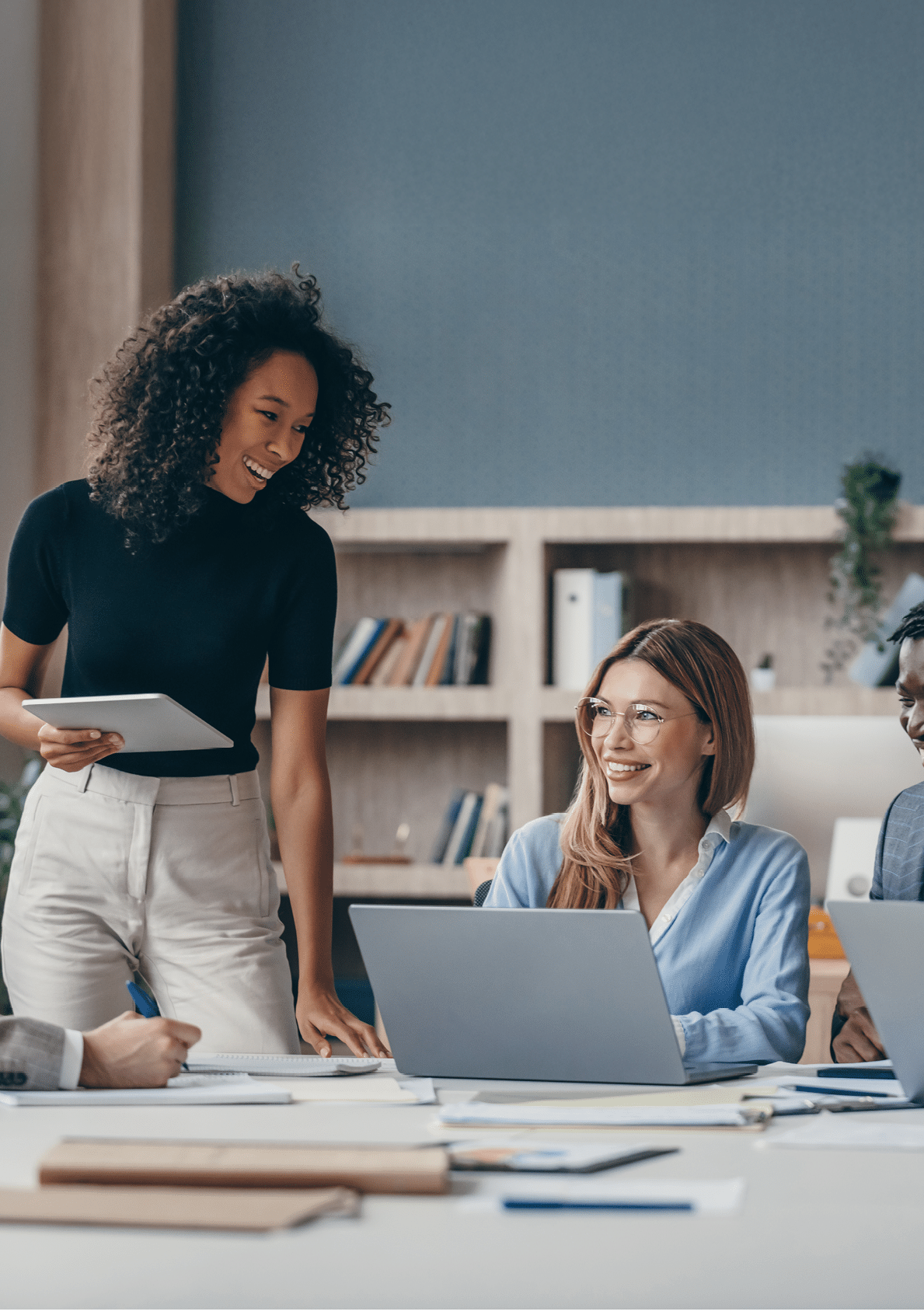 Happy group of business people discussing strategy during team meeting at the office desk together